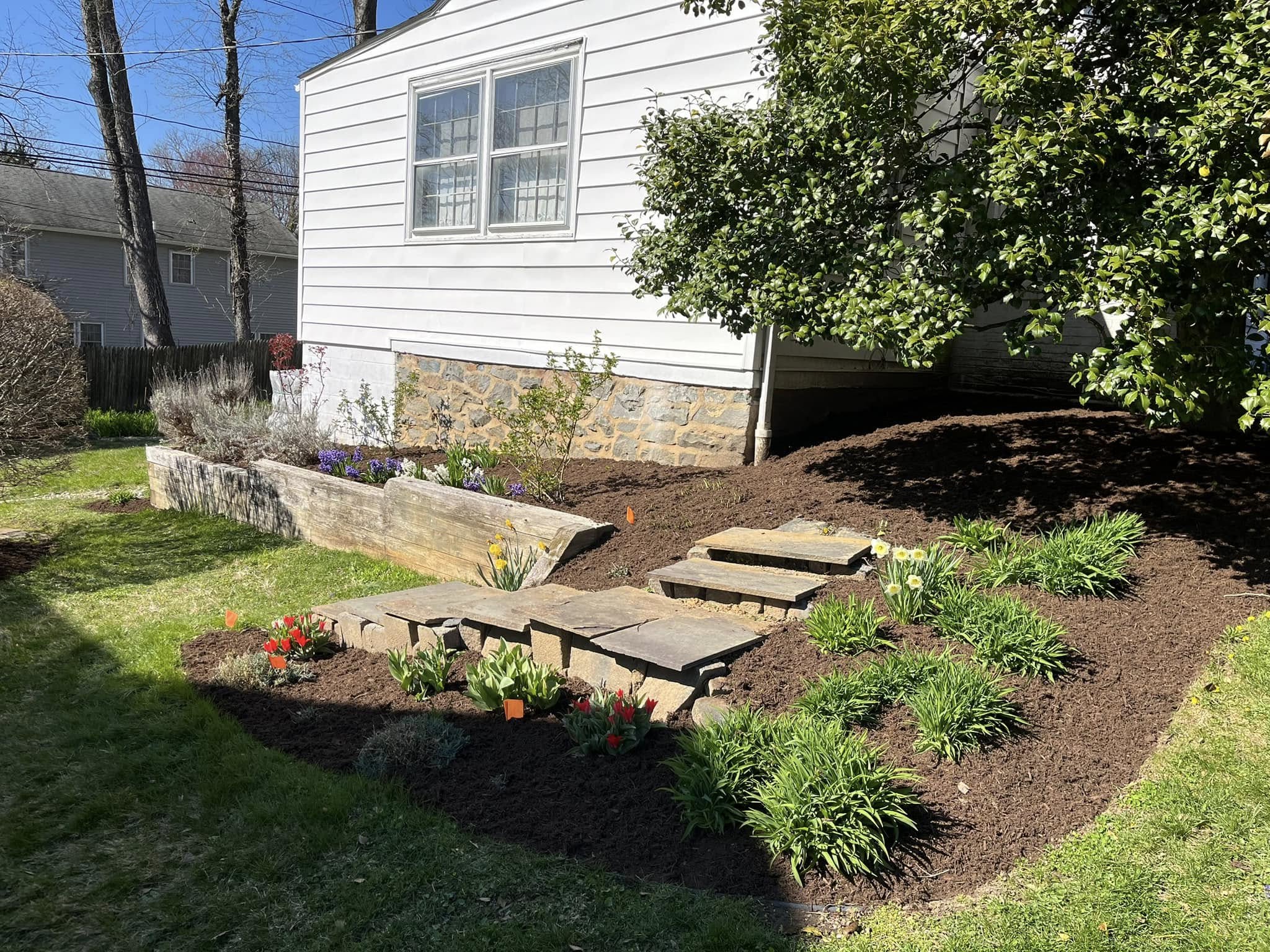 Stone retaining wall and garden bed installation